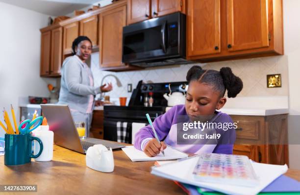 african-american girl studying, grandmother watching - kid homework kitchen stock pictures, royalty-free photos & images