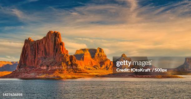 scenic view of rock formation in sea against sky during sunset,lake powell,united states,usa - lake powell stock pictures, royalty-free photos & images