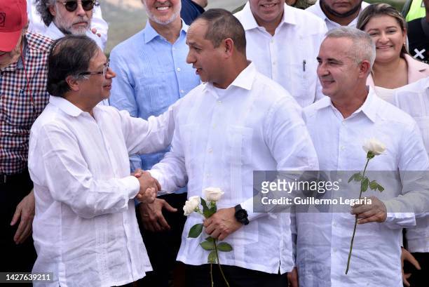 Colombian President Gustavo Petro shakes hands with Venezuelan Transport minister Ramon Araguayan as the Governor of the Venezuelan State of Tachira...