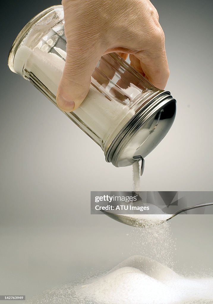 Sugar pouring over a spoon