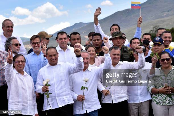 Colombian President Gustavo Petro waves next to Venezuelan Transport minister Ramon Araguayan and the Governor of the Venezuelan State of Tachira...