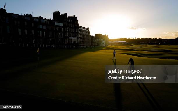 Players putt out on the 18th green as the sun sets on The Old Course prior to the Alfred Dunhill Links Championship at the Old Course St. Andrews on...