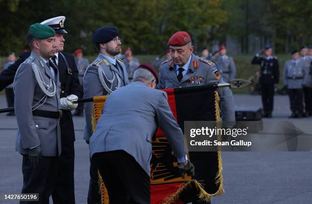 Lieutenant General Carsten Breuer , head of the new territorial defence command of the Bundeswehr, Germany's armed forces, unfurls a flag as attends...