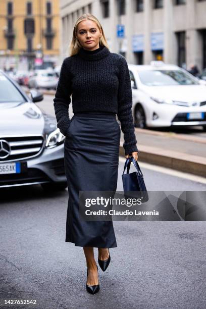 Guest is seen wearing a black turtleneck sweater and skirt outside the Ferrari show during the Milan Fashion Week - Womenswear Spring/Summer 2023 on...
