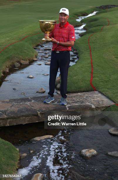 Captain Davis Love III of the United States Team poses with the Presidents Cup at the closing ceremony after defeating the International Team during...