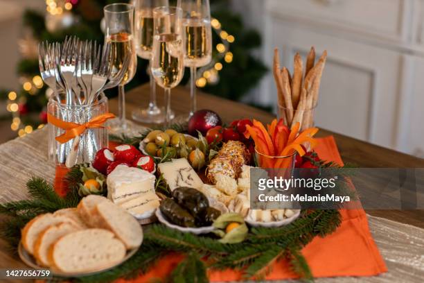 christmas brunch buffet spread with antipasti and champagne in festive rustic kitchen - delicatessen stock pictures, royalty-free photos & images