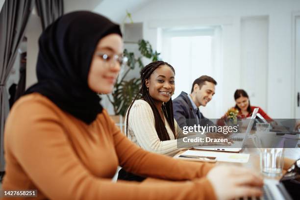 multi ethnic group of entrepreneurs working in office, using laptops and digital tablets - reopening ceremony stockfoto's en -beelden