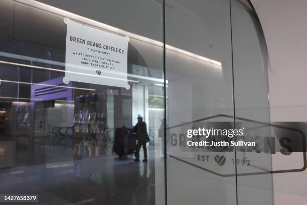 Sign is posted on the front of a cafe inside the international terminal at San Francisco International Airport as union food service workers are on...