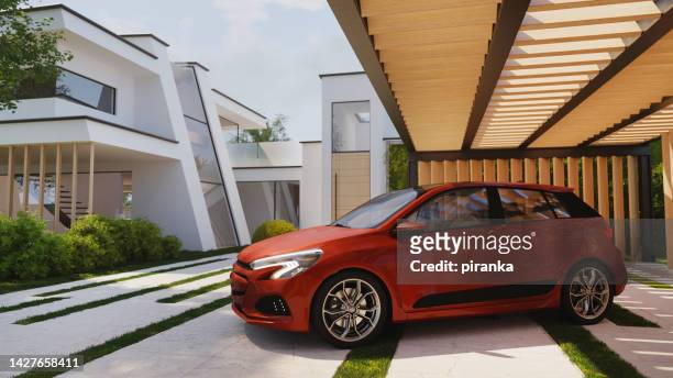 car on modern house driveway - red car stock pictures, royalty-free photos & images