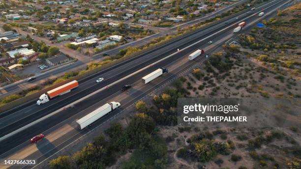 several semi trucks driving on a highway in texas, usa - drone view - texas road stock pictures, royalty-free photos & images