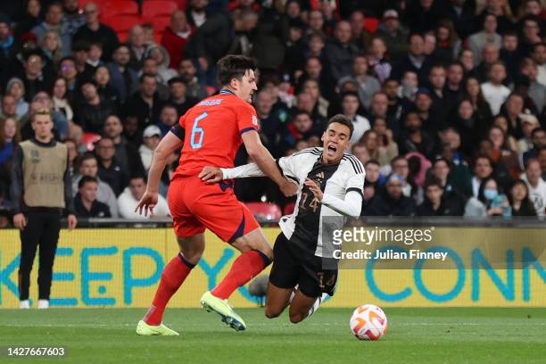 Jamal Musiala of Germany is fouled by Harry Maguire of England leading to a penalty being awarded after a VAR review during the UEFA Nations League...