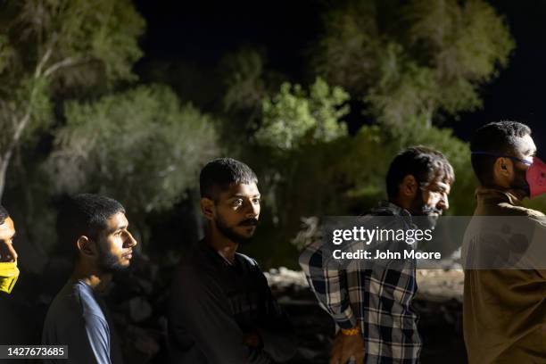 Immigrants from India seeking asylum in the United States wait to be processed by U.S. Border Patrol agents after crossing into Arizona from Mexico...