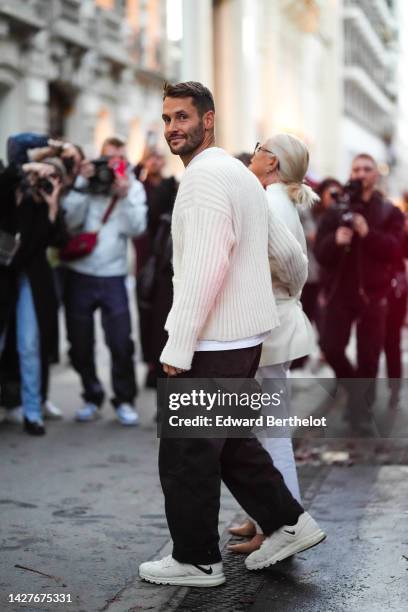 Simon Porte Jacquemus wears a white wool knitted pullover with v-neck, a white t-shirt, outside Jacquemus, during Paris Fashion Week - Womenswear...