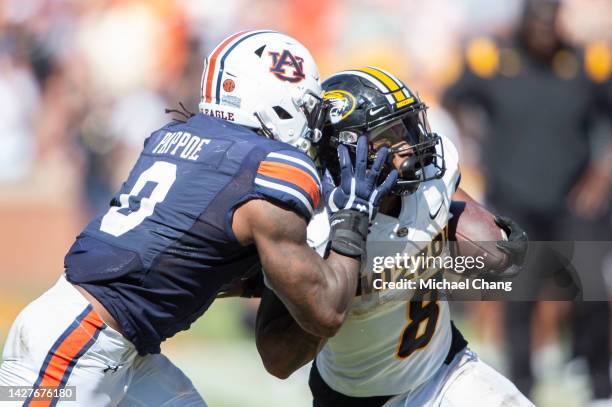 Linebacker Owen Pappoe of the Auburn Tigers looks to tackle running back Nathaniel Peat of the Missouri Tigers at Jordan-Hare Stadium on September...