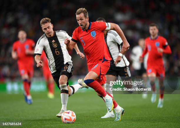 Harry Kane of England breaks away from Joshua Kimmich and Thilo Kehrer of Germany during the UEFA Nations League League A Group 3 match between...