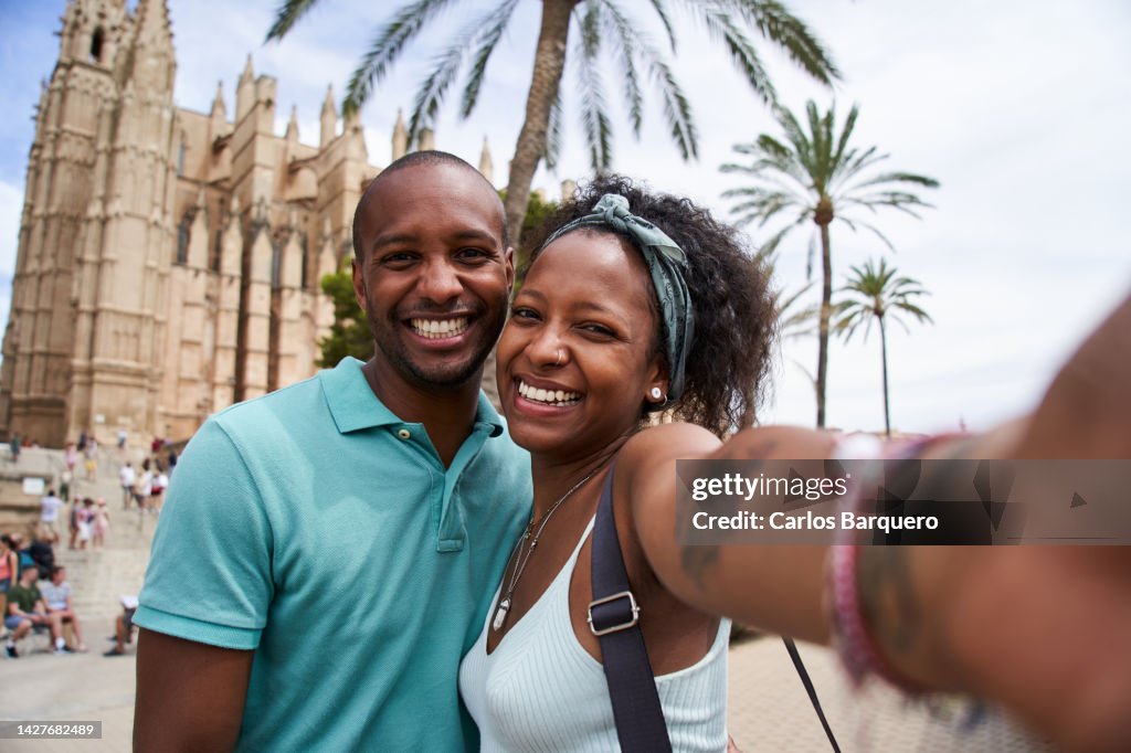 Cheerful selfie of two siblings or couple on their beach Holidays at Palma de Mallorca.