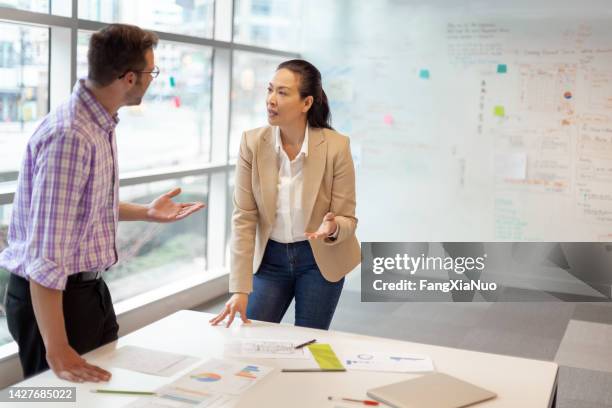 multiracial work colleagues having meeting in modern business office - conflito imagens e fotografias de stock