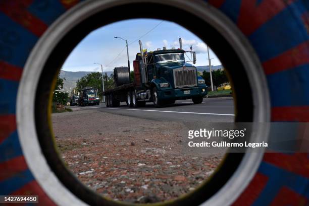 Venezuelan cargo trucks adorned with a Venezuelan flags enter to Cucuta after crossing the Simon Bolivar International Bridge during the commercial...