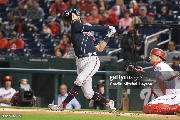 Dansby Swanson of the Atlanta Braves loses his helmet batting in the first inning against the Washington Nationals at Nationals Park on September 26,...