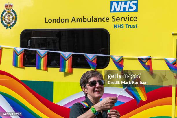 An ambulance worker from London Ambulance Service walks alongside a rainbow-coloured ambulance during the Pride in London parade on 1 July 2023 in...