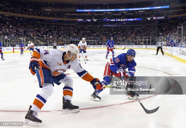 Scott Mayfield of the New York Islanders defends against Jimmy Vesey of the New York Rangers during the second period at Madison Square Garden on...