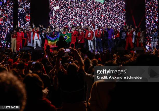 Brazil's former president and current presidential candidate Luiz Inacio Lula da Silva alongside artists sing to supporters during a gathering with...
