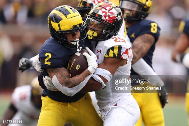 Blake Corum of the Michigan Wolverines tries to run through the tackle of Beau Brade of the Maryland Terrapins during the first half at Michigan...