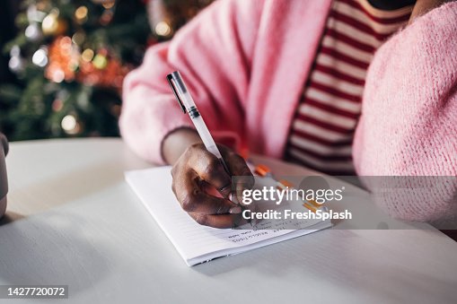 Woman Writing New Year's Resolutions Woman Writing New Year's Resolutions