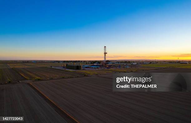 drone view drilling oil rig platform at dusk in new mexico - usa - carlsbad new mexico stock pictures, royalty-free photos & images