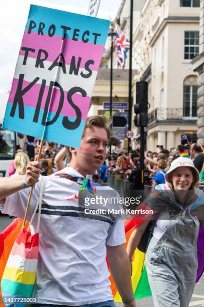 Participant holds a sign reading Protect Trans Kids during the Pride in London parade on 1 July 2023 in London, United Kingdom. Over a million people...