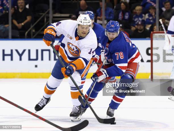 Brennan Othmann of the New York Rangers checks Andy Andreoff of the New York Islanders during the third period at Madison Square Garden on September...