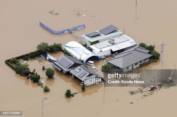 Photo taken from a Kyodo News helicopter shows houses inundated with floodwater in Mashiki in the southwestern Japan prefecture of Kumamoto on July 3...