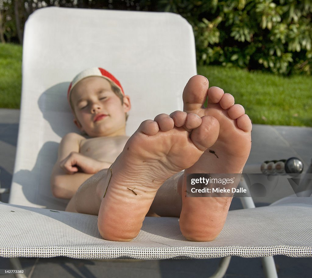 Child enjoying the sun on a lounger