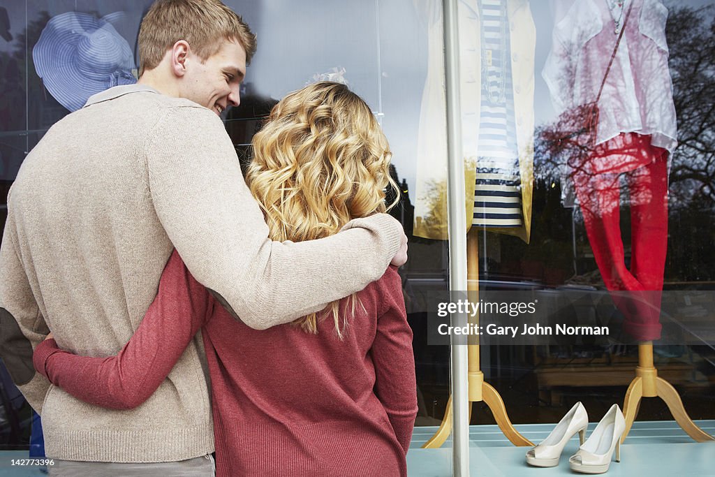 Young couple looking in Boutique shop window