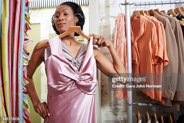 woman trying on dresses in boutique shop - silk draped stock pictures, royalty-free photos & images