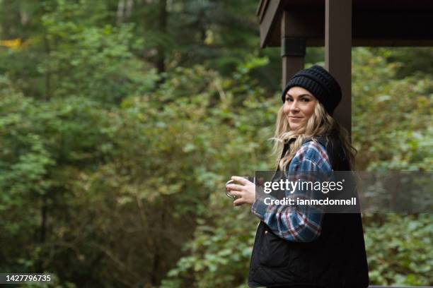 woman at a cabin on vacation in oregon - ski vest stock pictures, royalty-free photos & images