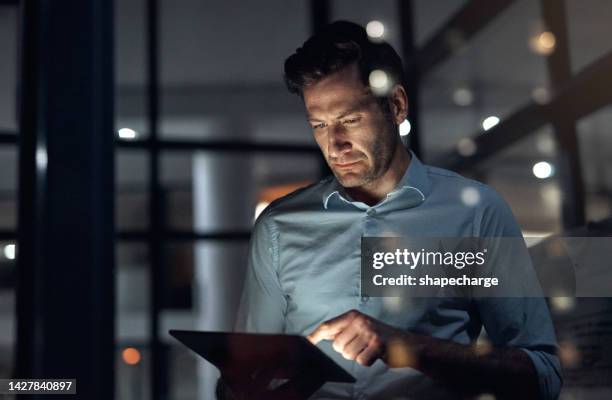 business man, tablet and working late at night while browsing the internet, doing online research or checking trading stats. serious entrepreneur using information technology for digital marketing - stern boss stock pictures, royalty-free photos & images