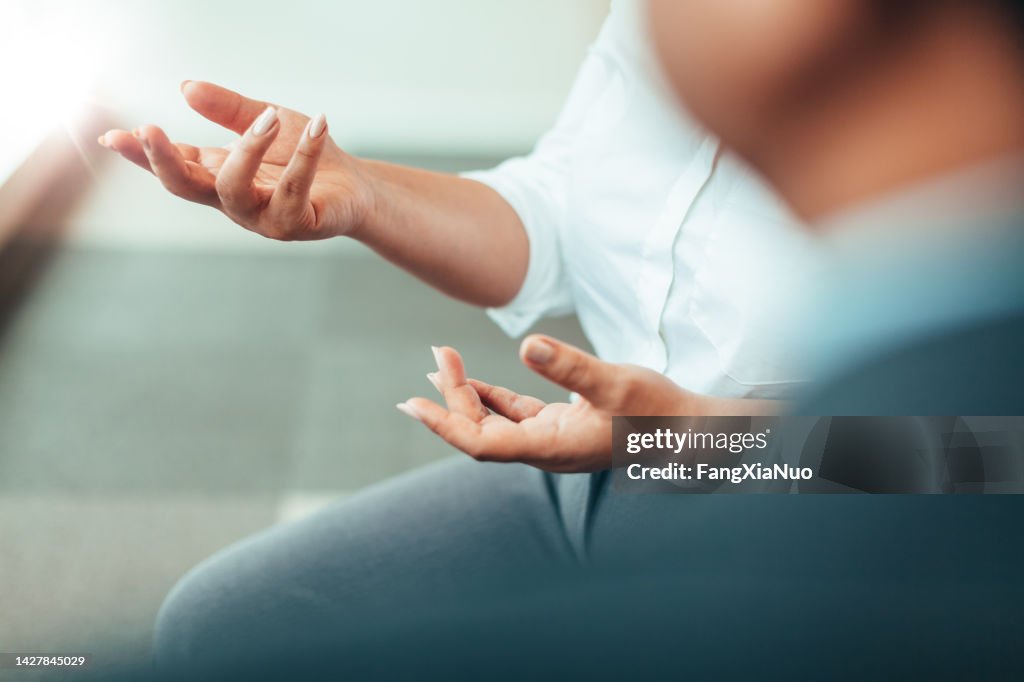 Hands of Asian African-American businesswoman talking discussing in a meeting in a business office therapy clinic in businesswear