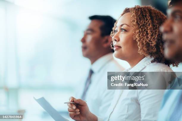 japanese african-american mature businesswoman student sitting learning listening in education training seminar meeting in business office classroom with multiracial colleagues - anticipation stock pictures, royalty-free photos & images