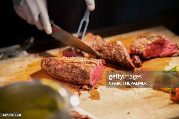 filet  - carving station at a party/event - carvery stockfoto's en -beelden