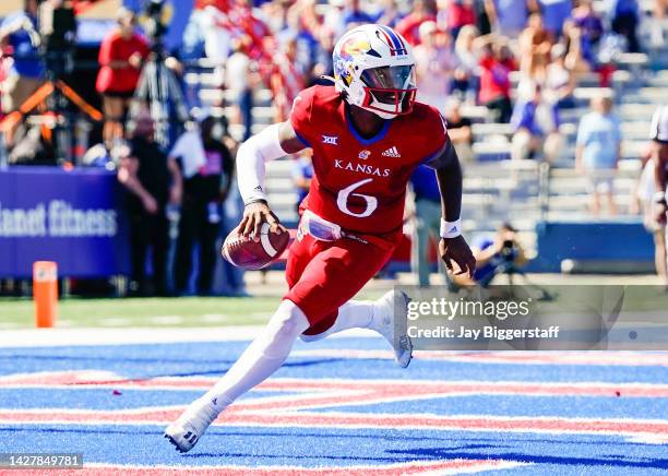 Jalon Daniels of the Kansas Jayhawks rolls out to pass during the second half against the Duke Blue Devils at David Booth Kansas Memorial Stadium on...