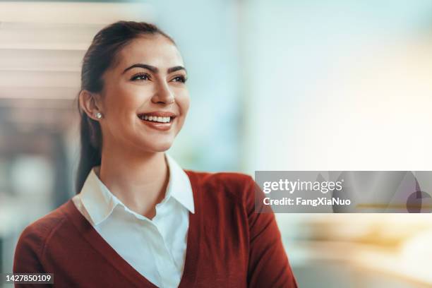 portrait of slavic woman student smiling positive emotion happiness looking away forward in aspiration success well-dressed in bright office - eastern european descent stock pictures, royalty-free photos & images