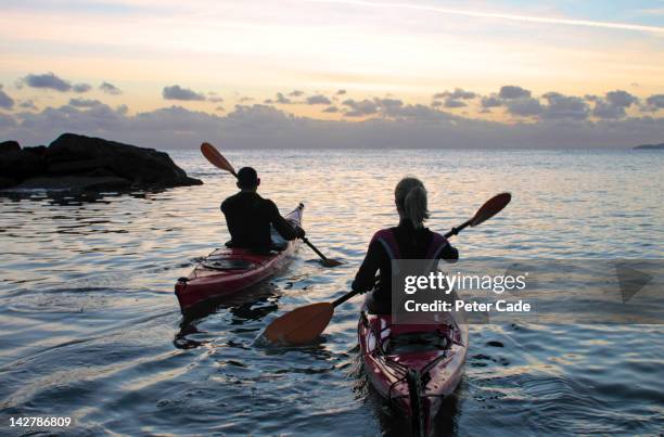 couple kayaking - couple sea uk stock pictures, royalty-free photos & images