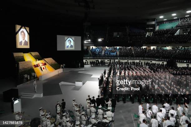 Attendants observe the national anthem during the state funeral for Japan's former prime minister Shinzo Abe on September 27, 2022 at the Budokan in...