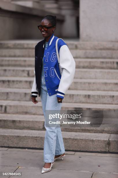 Fashion week guest seen wearing a Axel Arigato jacket with a jeans, outside Halpern Show during London Fashion Week, on September 18, 2022 in London,...