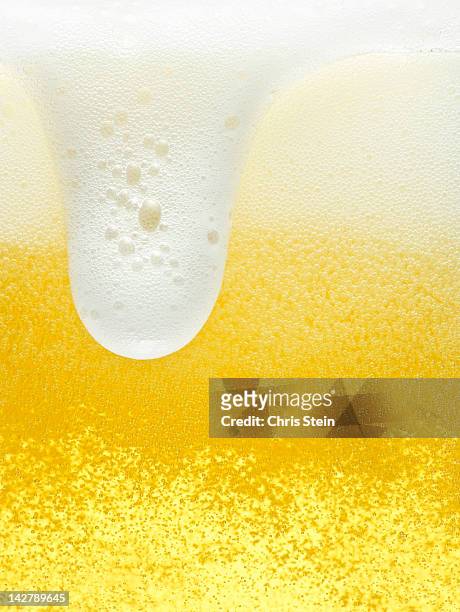 glass of overflowing beer foam - overflowing beer stock pictures, royalty-free photos & images