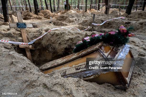 Silence, makeshift crosses, and open graves are all that remain after Ukrainian forensic and war crimes investigators complete their exhumation of...