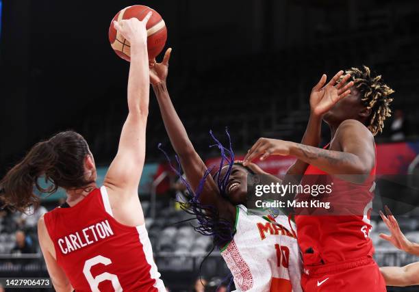 Maimouna Haidara of Mali is challenged by Bridget Carleton and Phillipina Kyei of Canada during the 2022 FIBA Women's Basketball World Cup Group B...