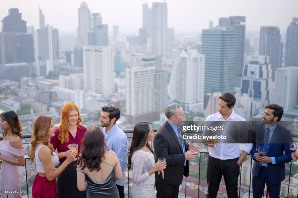 Business celebration at rooftop bar in the city.