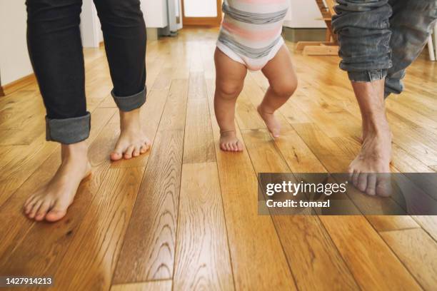 parents teaching their child to walk - man walking feet inside stock pictures, royalty-free photos & images